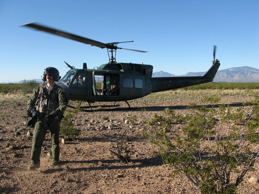 <p>A member of a helicopter flight crew participating in Operation Angel Thunder walks across the desert in southern Arizona.</p>
