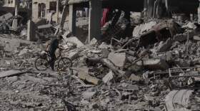A man pushes his bicycle through rubble in Gaza City, Sunday, Oct. 12, 2025, after Israel and Hamas agreed to a pause in their war and the release of the remaining hostages. (Jehad Alshrafi/AP)