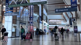 Travelers move through Will Rogers International Airport on Dec. 12, 2025.