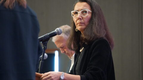 Mary Peltola listens to a question posed by moderator Michelle Egan at a candidate forum held by the Alaska Oii and Gas Association on Aug. 27, 2026. Next to Peltola is i Sen. Dan Sullivan. Peltola, a Democrat and former U.S. House member, is challenging Sullivan.