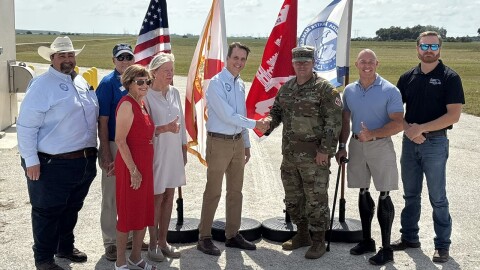 U.S. Army Corps of Engineers Jacksonville District Commander Col. Brandon Bowman and South Florida Water Management District Executive Director Drew Bartlett (center) shake hands to celebrate the milestone completions at the Indian River Lagoon South project. 