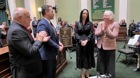 Ruggerio’s children, Charles Ruggerio and Amanda Fallon, flank the plaque dedicated to their father, surrounded by Senate Majority Leader Frank Ciccone (left) and Senate President Val Lawson (right).