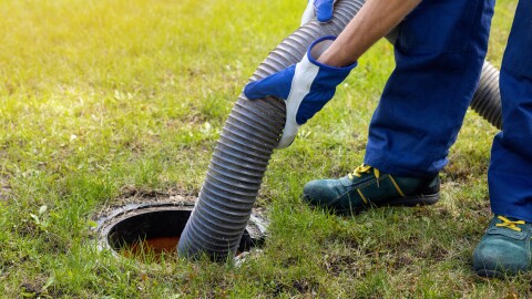 Man pumping out house septic tank.