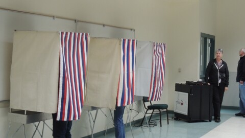 Voters fill out their ballots at the District 2 polling location on Aug. 16.