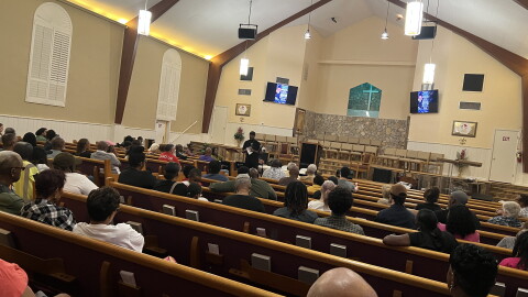 People gather in Greater Peace Missionary Baptist Church for a town hall meeting