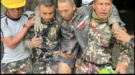 A Chinese national is seen after being rescued by soldiers during an ongoing operation at the Trisuli-3A hydropower project in Nepal's Rasuwa district, September 5, 2026
