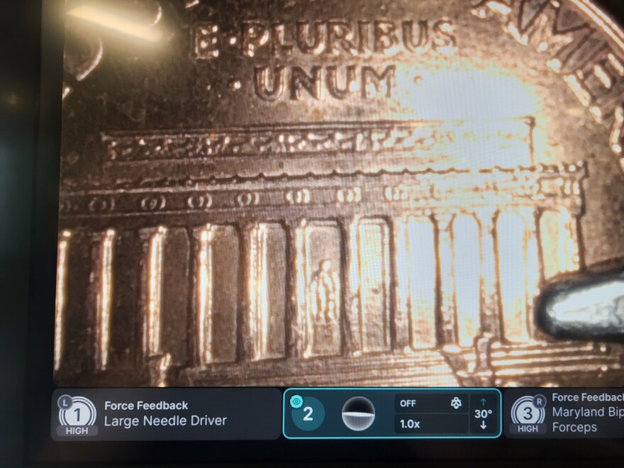 Abraham Lincoln's statue inside the Lincoln Memorial, as seen on the back of a penny through the lenses of a surgical robot in Albany, April 9th, 2025.