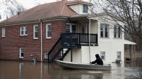 A resident uses a rowboat to navigate a flooded neighborhood on Feb. 22, 2018 in Lake Station, Ind. Heavy rains and snow melt have caused flooding in Indiana, Illinois, Michigan, Wisconsin and other Midwest states. (Scott Olson/Getty Images)