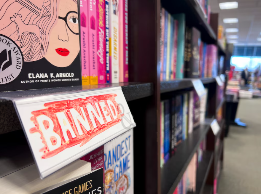 A sign indicates that a book for sale at a Barnes and Noble in Salt Lake City has been banned in Utah public schools.