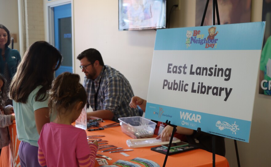 Two children selecting free goodies from East Lansing Public Library
