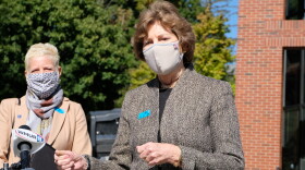Senator Jeanne Shaheen standing at microphone next to UNH senior vice provost Marian McCord.