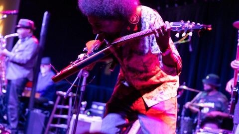Blues musician Selwyn Birchwood strumming his base guitar at the Arts Garage in Delray Beach, a performing arts venue featuring music, theatre, visual arts, comedy, and arts education programming. 