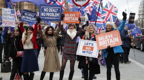Leavers hold up signs next to pro-European demonstrators protesting opposite the Houses of Parliament in London, Tuesday, Jan. 15, 2019.(Frank Augstein/AP)