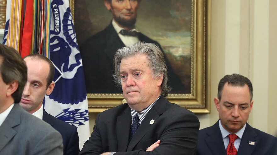Steve Bannon, then President Trump's chief strategist, listens as Trump speaks on April 20, 2017, before signing a memorandum on the investigation of steel imports.