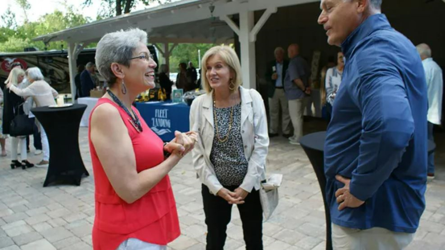 Joanne Hickox, left, founder and executive riector of Seniors on a Missions, talks with kathy and Reid Estes of St. Augustine at a recent fundraiser
