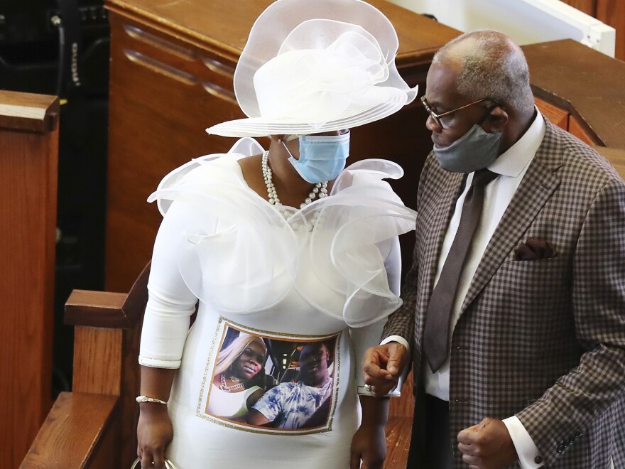 Tomika Miller, the widow of Rayshard Brooks, wears a white dress bearing a photograph of herself and her husband during his public viewing at Ebenezer Baptist Church on Monday.