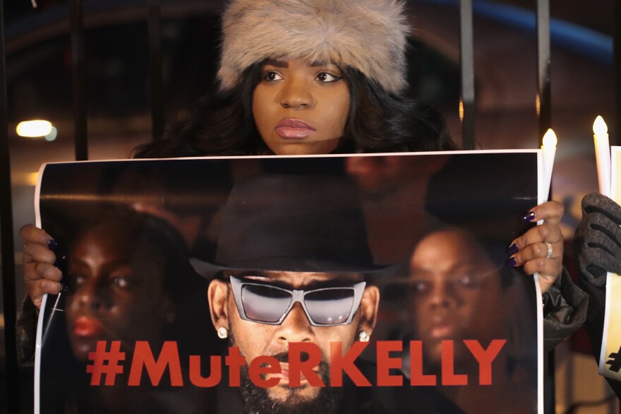Demonstrators near R. Kelly's studio call for a boycott of his music on Jan. 9, 2019.