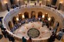 Children and parents from Annunciation School sing Feb. 24, 2026, inside the Capitol during a rally urging lawmakers to pass gun safety measures.