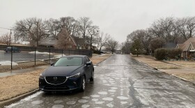 A car is parked on an icy road in midtown Tulsa.