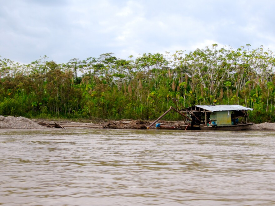 A gold-mining barge docks along the Madre de Dios river.