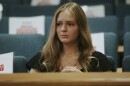 woman with blond hair with sad look almost near tears in area of public seating 