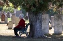 Jane Hopkins sits on a bench in Lakeview Cemetery in Williamson, one of the cemeteries featured in her book, "Buried Rochester New York Area: 200 Years of Cemetery History."