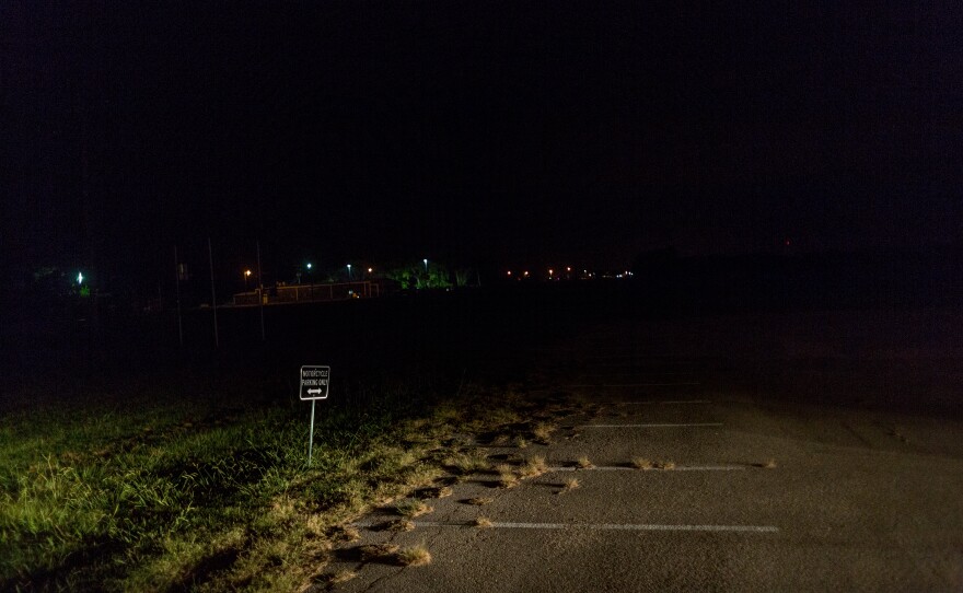 A sign marks spaces reserved for motorcycles at a parking lot in West Tawakoni, TX.