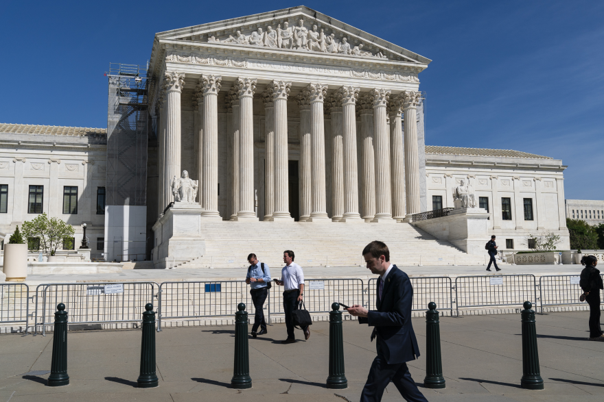 People commute near the U.S. Supreme Court on Tuesday, April 16, 2024, in Washington, D.C.