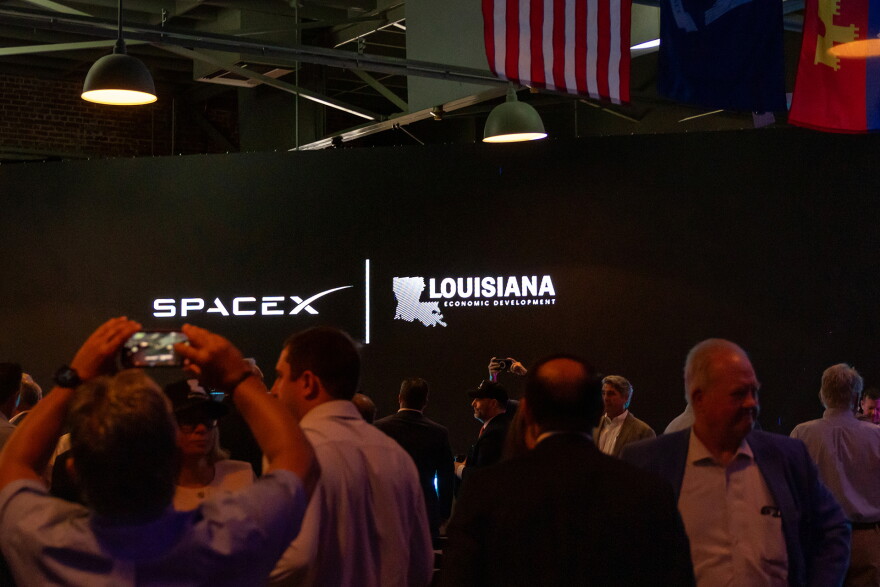 SpaceX and Louisiana Economic Development logos appear on a screen inside an event hall in downtown Abbeville, Louisiana, during the SpaceX announcement on Tuesday, August 25, 2026. 