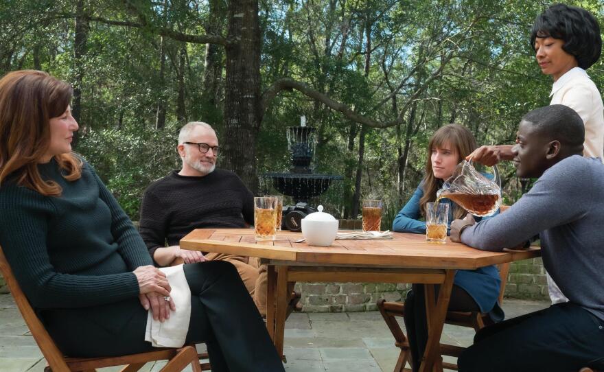 Chris sits down for tea with Rose's parents in <em>Get Out</em>. (From left, Catherine Keener, Bradley Whitford, Allison Williams, Betty Gabriel and Daniel Kaluuya).