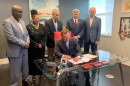 Mayor Curry signing bill with city councilmen and councilwoman behind him