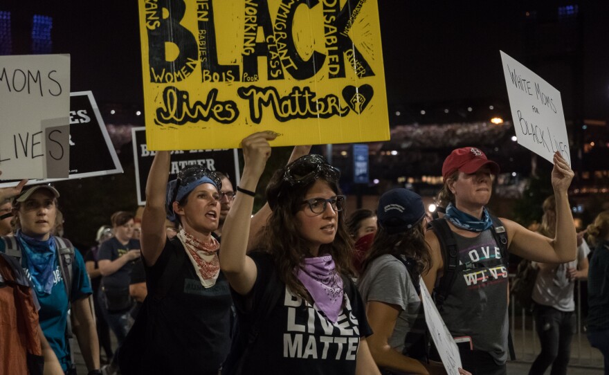 Protesters walk past Busch Stadium during a 'white allies' rally Thursday, Sept. 21, 2017. The demonstration blocked two gates to the stadium during a Billy Joel concert on Sept. 21, 2017.