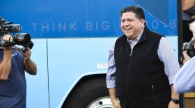 Pritzker gets off a bus