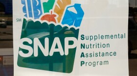 A sign on the door of a retailer reads "We Accept SNAP Supplemental Nutrition Assistance Program"