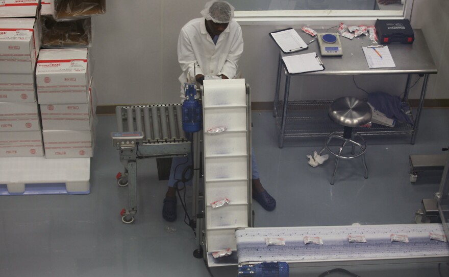 Meds and Food for Kids started making enriched peanut butter in 2003 by grinding peanuts and mixing the ingredients by hand. Today, it has a modern factory.