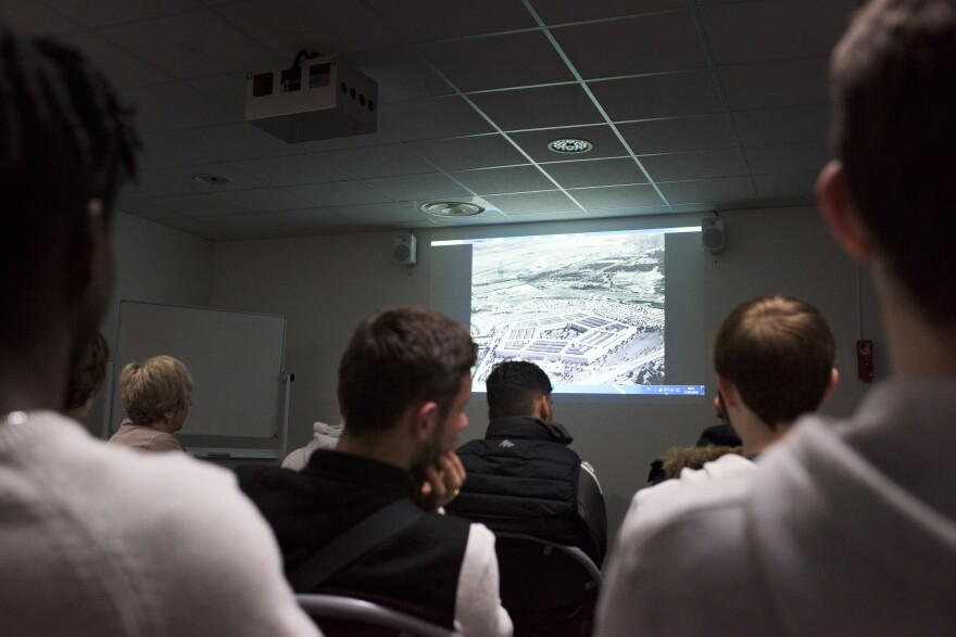 Students watch a conspiracy video created by Huchon at Lycee Baggio High School in Lille, France. The video is part of Huchon's group Conspi Hunter's curriculum on identifying fake news.