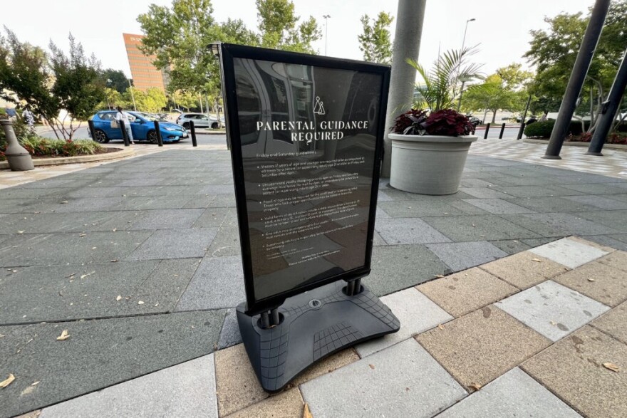 A sign at the Mall in Columbia, a suburban shopping center in central Maryland, requires anyone under 17 to be accompanied by a parent or supervising adult on Friday and Saturday evenings. Public spaces and commercial areas across the country are increasingly imposing curfews and other restrictions on young people.