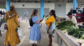 Lake Effect's Joy Powers chatting with Dig In! contributor Venice Williams at the Fondy Farmer's Market.
