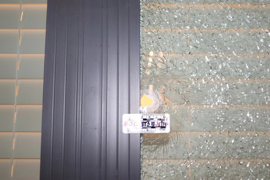 A bullet hole in the bedroom window of an apartment near the breezeway where Alea Bates was shot in 2019.