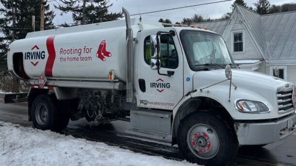 An Irving Oil truck is parked on a snowy street