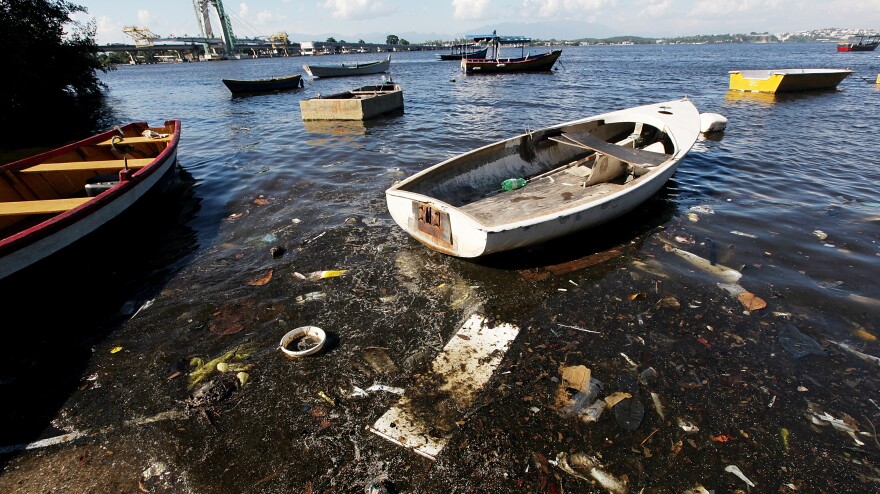 Boats float along the shoreline of the polluted waters of Guanabara Bay on Jan. 21 in Rio. The bay will be the site of sailing events during the Olympics. Local residents recently protested the high level of pollution.