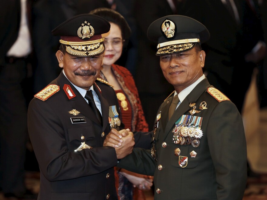 The head of Indonesia's Armed Forces Gen. Moeldoko (right) congratulates the country's new national police chief, Badrodin Haiti, last month. Moeldoko recently defended the Indonesian military's use of virginity tests for female recruits.