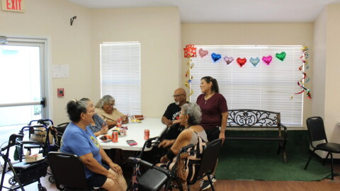Residents of the Olivares Senior Community talk with the building's assistant manager Joann Olveda after electricity was restored on Aug. 30, 2026.