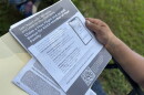 Tito Sabillón holds a flyer he received in the mail from the U.S. Department of Homeland Security encouraging undocumented immigrants to self-deport using an app from Customs and Border Protection.