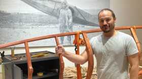 Qayak builder Lou Logan shows off the qayak frame he’s been constructing using traditional methods inside the Alaska State Museum.