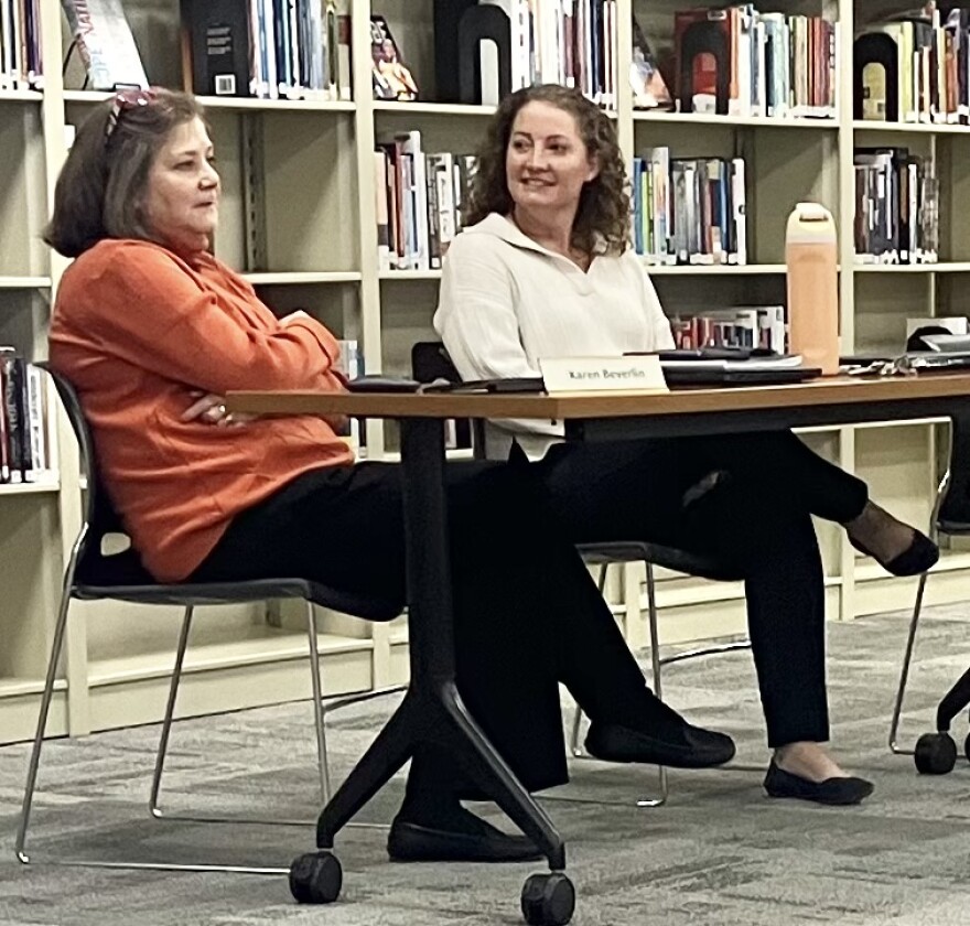 Karen Beverlin (left) and Lindsay Winter chat Wednesday before a special meeting of the Washington Community High School board. Winter is the high school's administrator for instructional data and research.