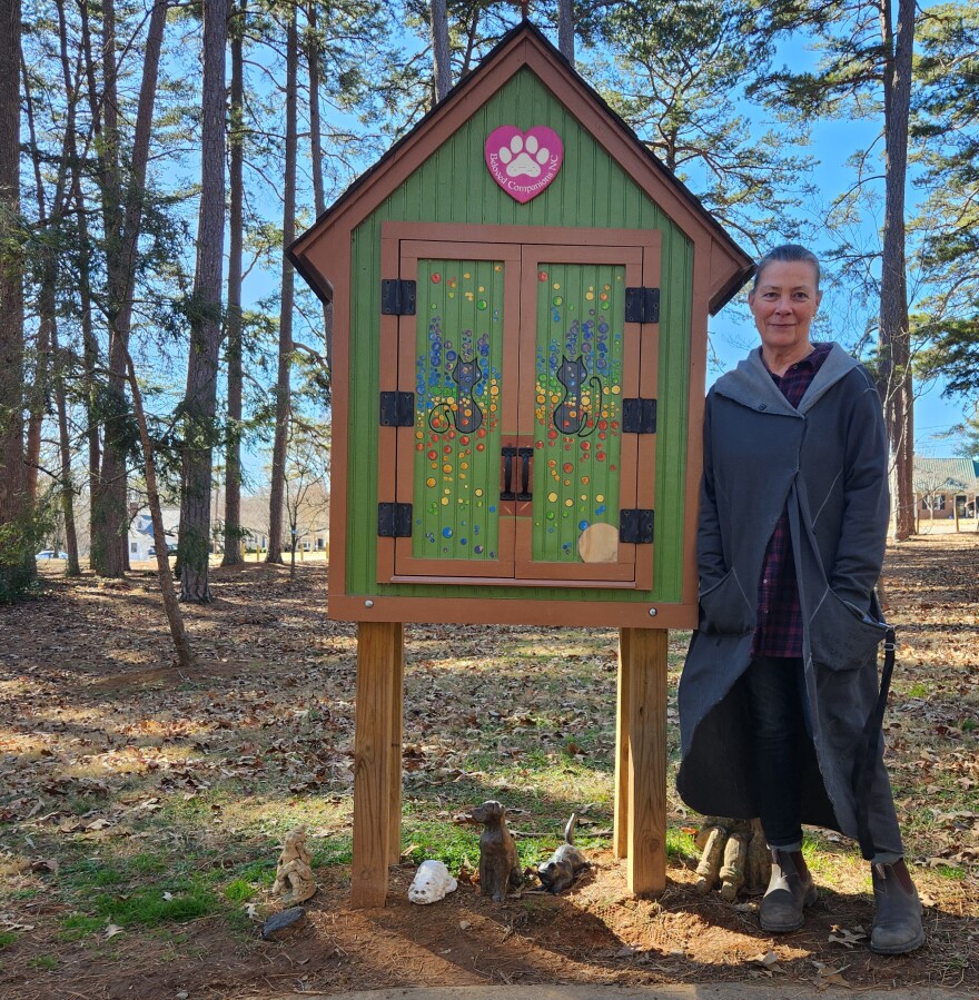 Lynn Byrd poses by a Little Pet Chapel in Winston-Salem's Miller Park. NEAL CHARNOFF/WFDD