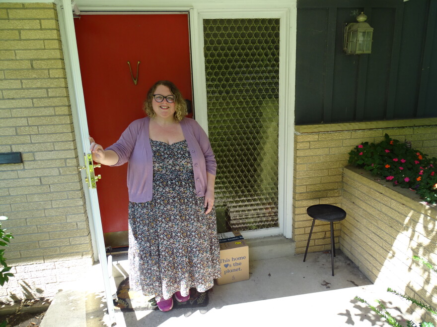 Jessi Young standing outside of her home. 