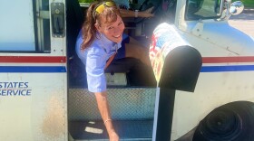 City Letter Carrier Lisa Darley picks up food by a mailbox in Kirby on Stamp Out Hunger Day May 9th, 2026