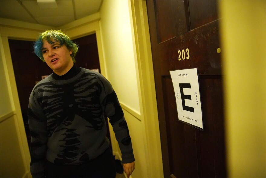 Kaden Jarosz shows a multi-stalled bathroom inside his Oberlin College residence hall on Monday, Dec. 16, 2024, that uses the "E-system" to indicate with whom students are comfortable sharing the space. "E" stands for "everyone."